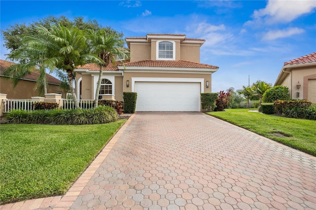 mediterranean / spanish-style home featuring a garage and a front lawn