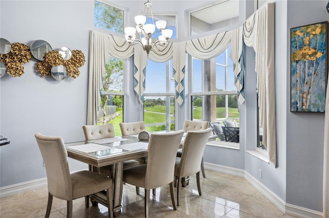 dining area featuring a wealth of natural light and a notable chandelier