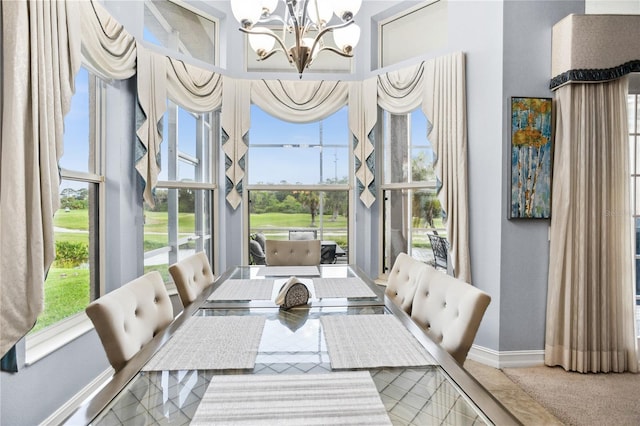 carpeted dining space featuring a notable chandelier