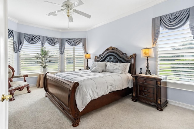 carpeted bedroom featuring multiple windows, ceiling fan, and ornamental molding