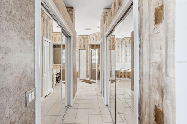 hallway with light tile patterned floors