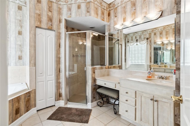 bathroom featuring tile patterned flooring, vanity, and plus walk in shower