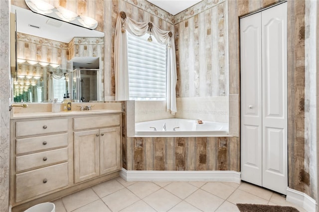 bathroom featuring vanity, tile patterned floors, and tiled tub