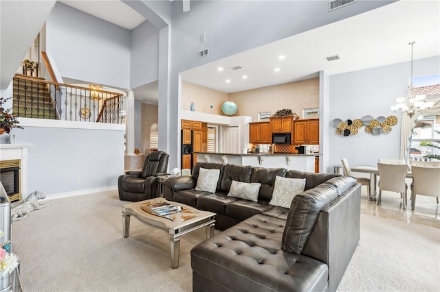 living room featuring light carpet, a towering ceiling, and an inviting chandelier