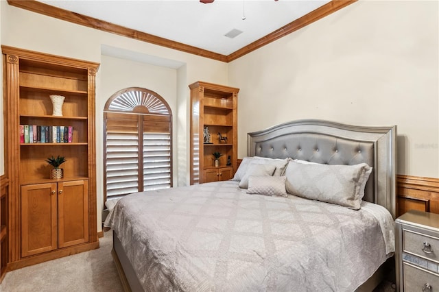 carpeted bedroom featuring ceiling fan and crown molding