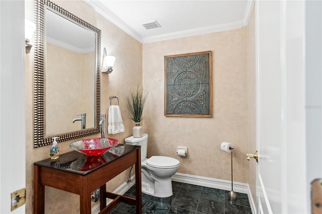 bathroom featuring crown molding, sink, and toilet