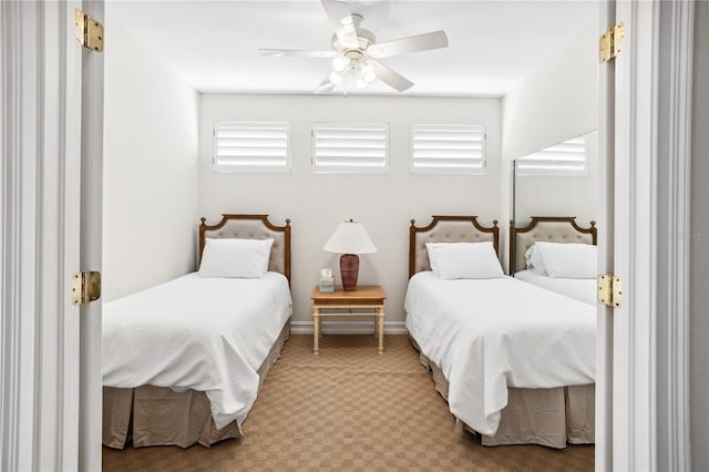 bedroom with ceiling fan, carpet floors, and multiple windows