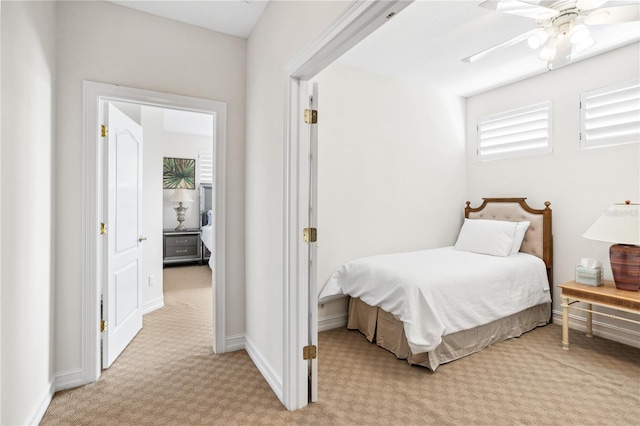 bedroom with ceiling fan and light carpet