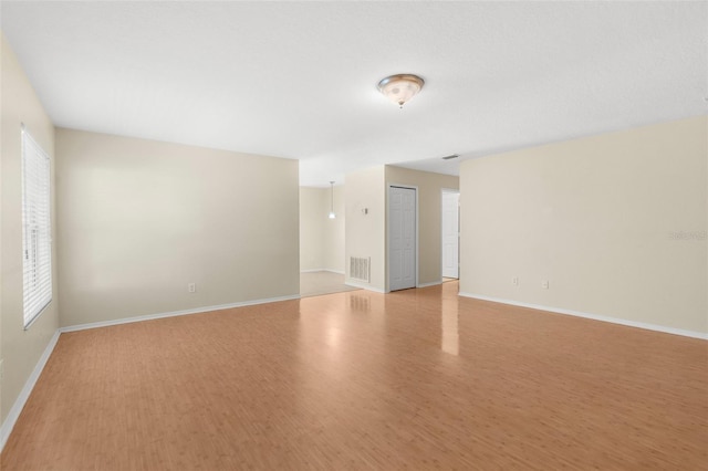 spare room featuring light hardwood / wood-style floors