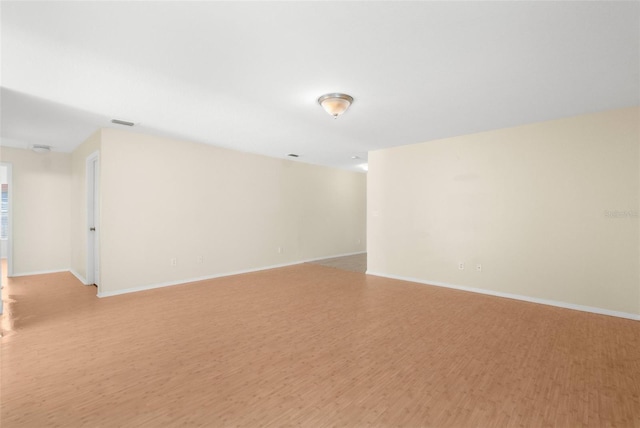 unfurnished room with light wood-type flooring