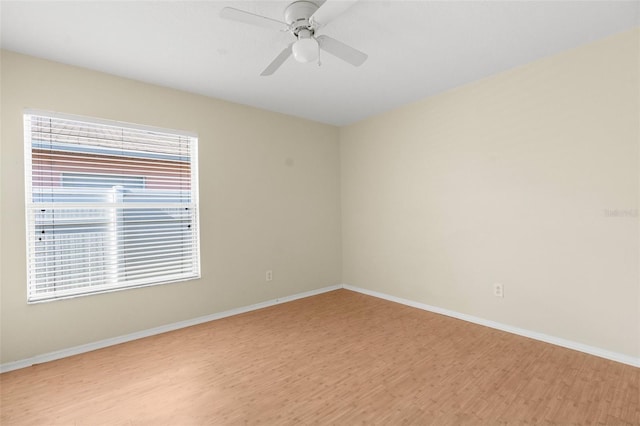 spare room featuring ceiling fan and light wood-type flooring