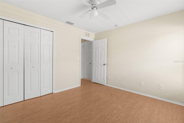 unfurnished bedroom with ceiling fan, a closet, and light hardwood / wood-style floors