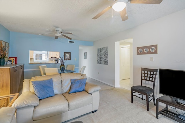 living room featuring light colored carpet and a textured ceiling