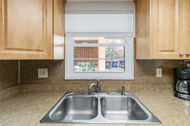 kitchen with decorative backsplash, sink, and light brown cabinets