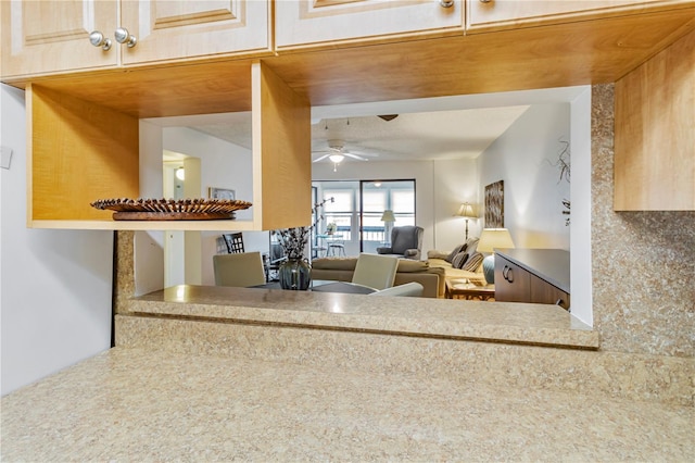 kitchen featuring ceiling fan and decorative backsplash