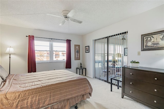 bedroom featuring light carpet, ceiling fan, and a textured ceiling