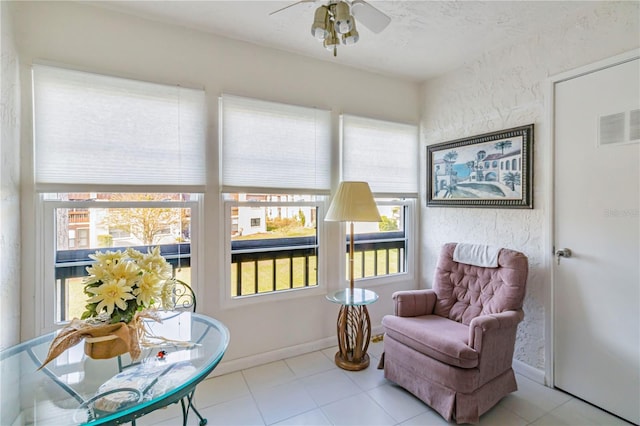 sunroom / solarium with a wealth of natural light and ceiling fan