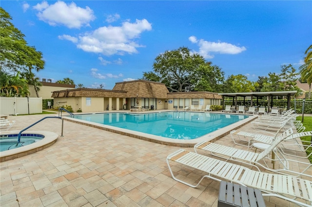 view of swimming pool featuring a patio area and a community hot tub