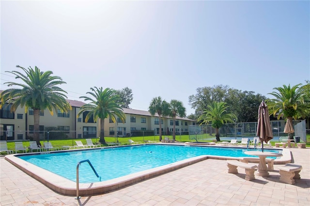 view of swimming pool with a patio and a lawn