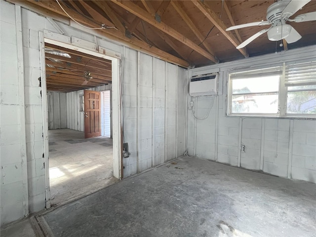 basement featuring ceiling fan and a wall unit AC