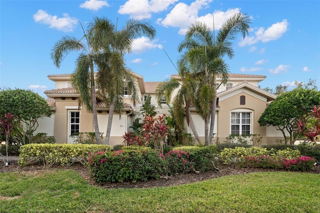 mediterranean / spanish-style house with a front yard