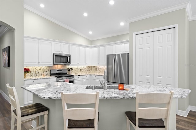 kitchen with stainless steel appliances, a large island, and white cabinets