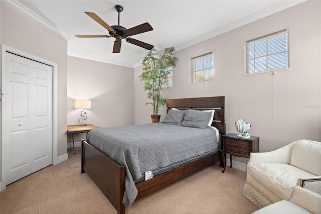 carpeted bedroom with crown molding, ceiling fan, a closet, and a textured ceiling