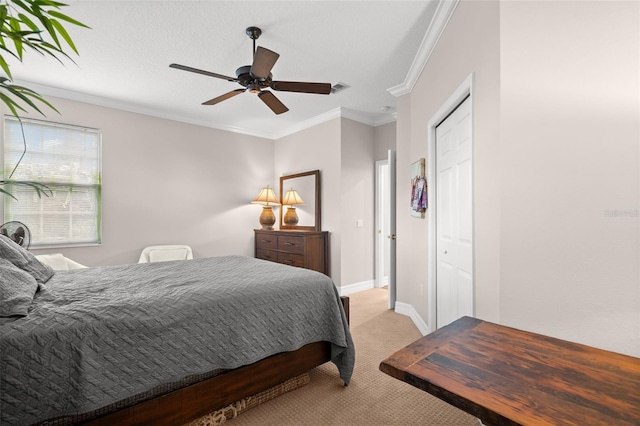 carpeted bedroom featuring crown molding, a textured ceiling, ceiling fan, and a closet