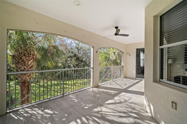 view of patio / terrace with a balcony and ceiling fan