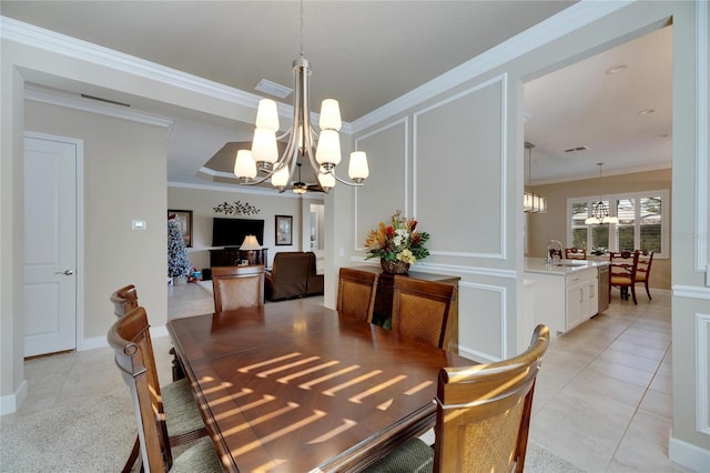 dining room with light tile patterned flooring, crown molding, sink, and an inviting chandelier