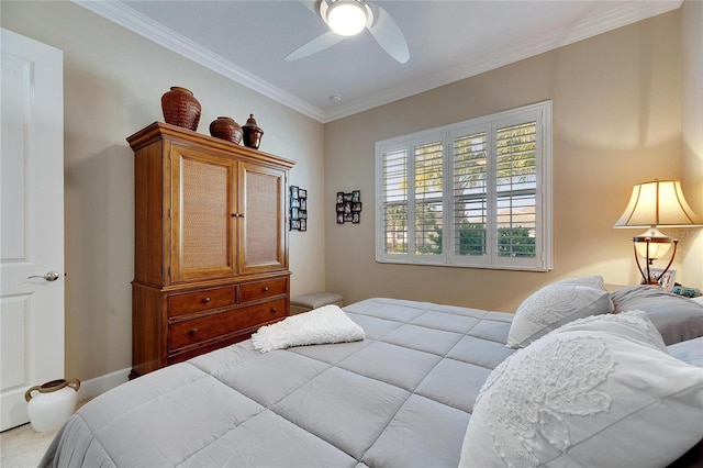 bedroom featuring ceiling fan, ornamental molding, and carpet floors