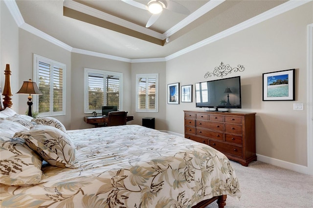 carpeted bedroom with a raised ceiling, ceiling fan, and crown molding