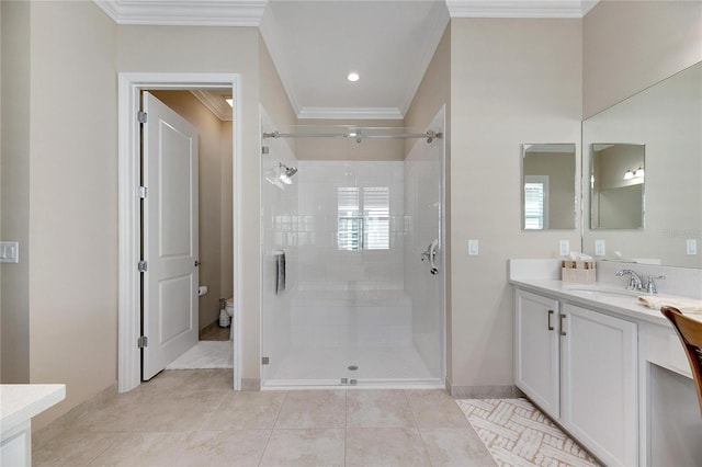 bathroom with tile patterned flooring, vanity, a wealth of natural light, and crown molding