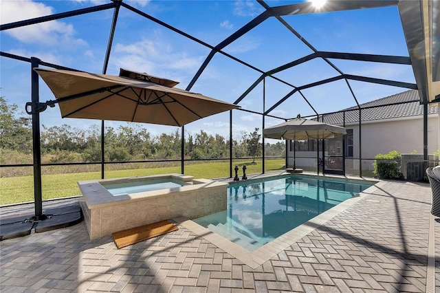 view of swimming pool featuring an in ground hot tub, a patio area, a lanai, and a lawn