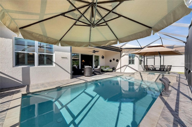 view of pool featuring a patio, ceiling fan, and a lanai