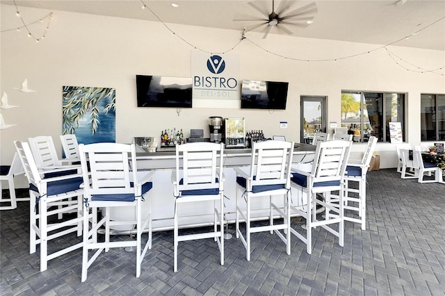 view of patio featuring an outdoor bar and ceiling fan