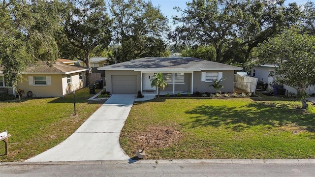 single story home with a garage and a front lawn