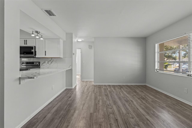 unfurnished living room with hardwood / wood-style flooring