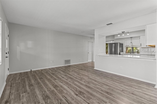 unfurnished living room featuring hardwood / wood-style floors