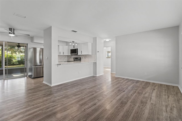 unfurnished living room with hardwood / wood-style floors and ceiling fan