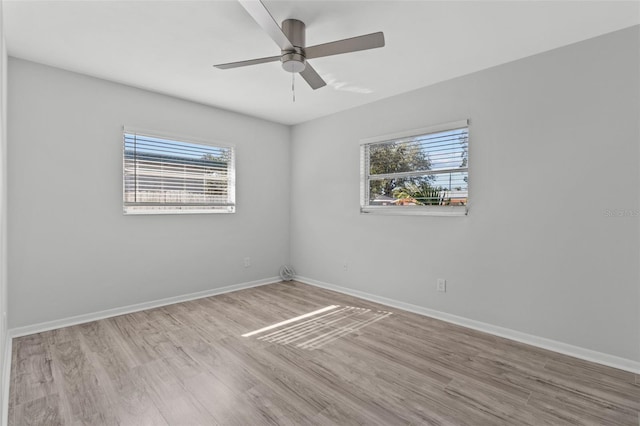 unfurnished room with ceiling fan, a healthy amount of sunlight, and light hardwood / wood-style floors