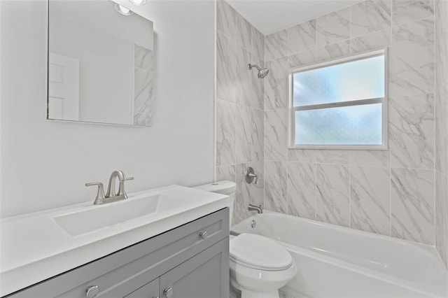 full bathroom with vanity, tiled shower / bath combo, and toilet