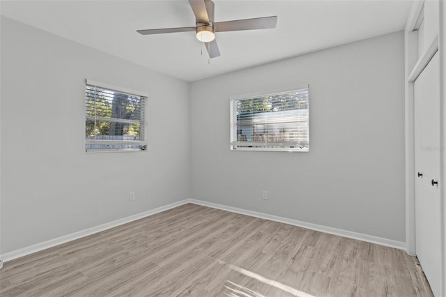 unfurnished bedroom with ceiling fan, light hardwood / wood-style floors, and a closet