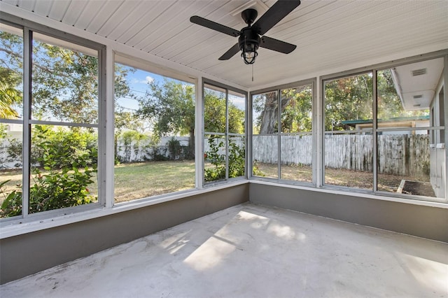 unfurnished sunroom featuring ceiling fan