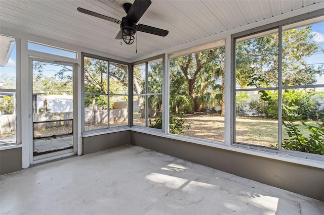 unfurnished sunroom with a wealth of natural light, ceiling fan, and wood ceiling