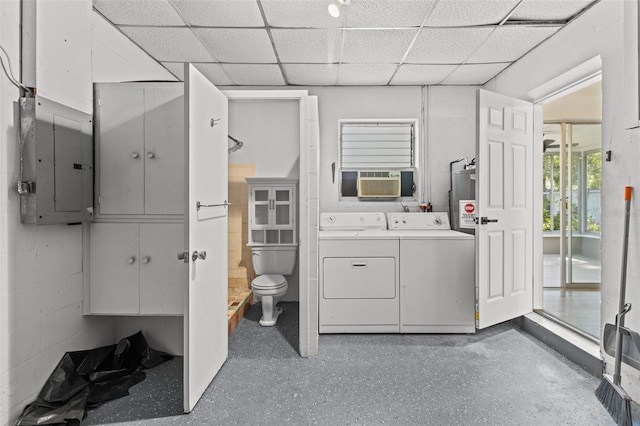 washroom featuring gas water heater, electric panel, and washer and clothes dryer