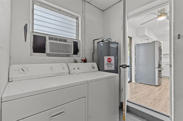 laundry area featuring washer and clothes dryer, ceiling fan, a wall mounted AC, light hardwood / wood-style floors, and water heater