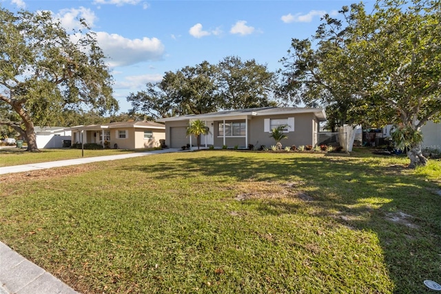 ranch-style home with a front lawn and a garage