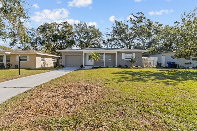 ranch-style home with a front yard and a garage