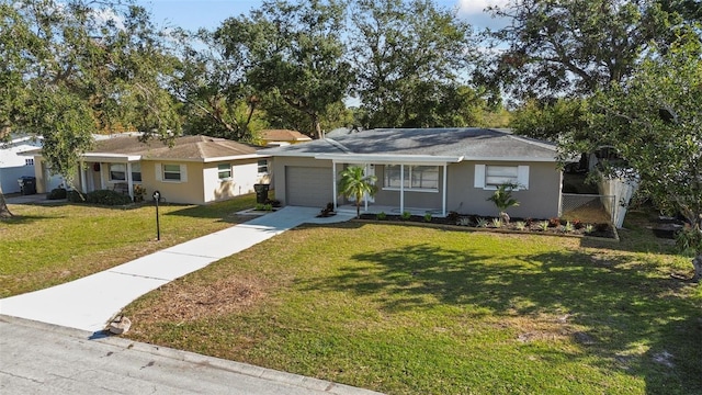 ranch-style house featuring a garage and a front lawn